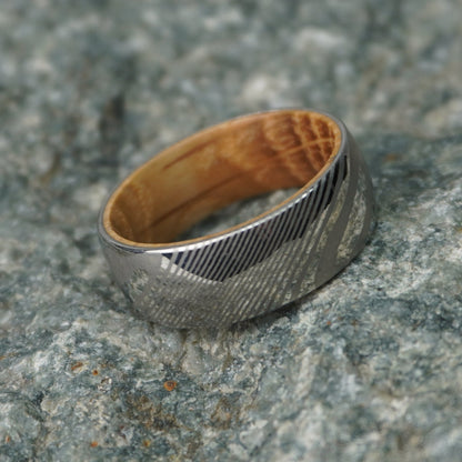 Artisan Damascus ring with a wood interior, by Forge and Lumber, available in sizes UK M, N, O.