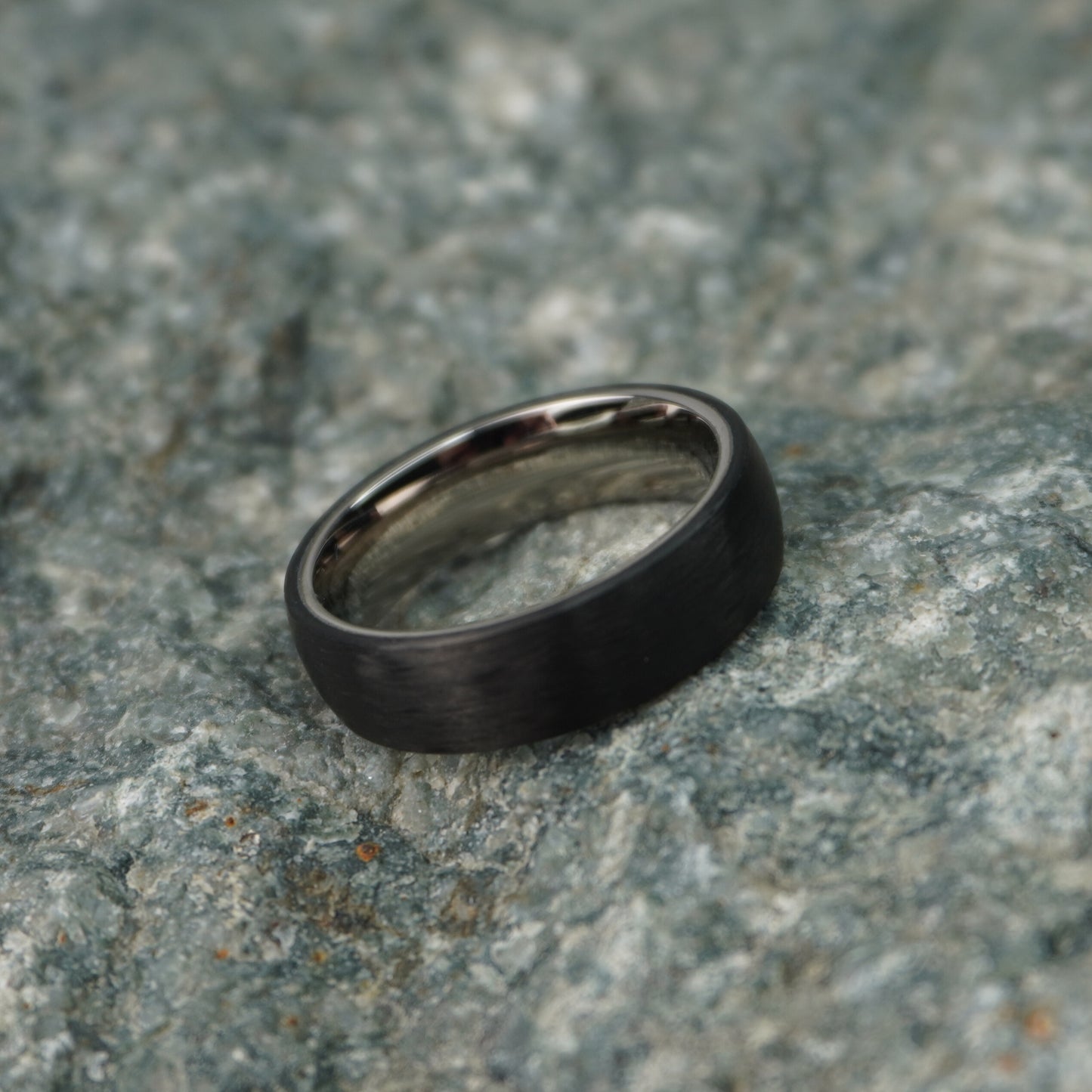 Black 6mm carbon fiber ring by Forge and Lumber, featuring a sleek, modern design.