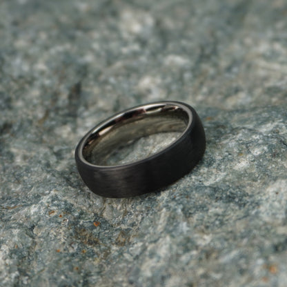 Black 6mm carbon fiber ring by Forge and Lumber, featuring a sleek, modern design.