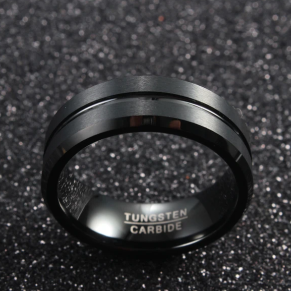 Black beveled tungsten carbide ring by Forge and Lumber, featuring an 8mm width, available in sizes UK M to O.